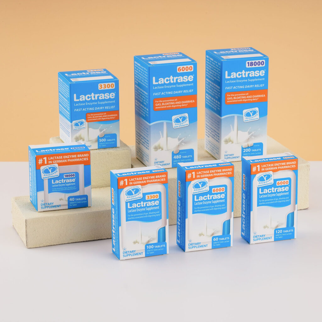 Arrangement of several Lactrase packages in different sizes on a beige background